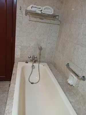 a bath tub in a bathroom with a shower at KL Advice Suite At Times Square in Kuala Lumpur