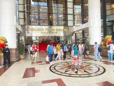 a group of people walking in a building at Sunrise Residence At Berjaya Times Square AR in Kuala Lumpur