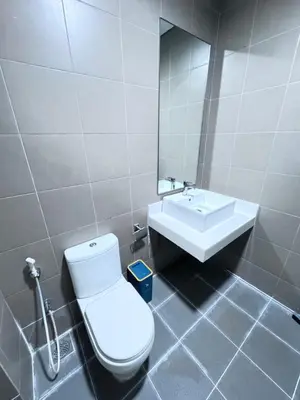 a bathroom with a white toilet and a sink at Mercu Summer suites KLCC by JK Privy Homes - 7 Pax Family Stay in Kuala Lumpur