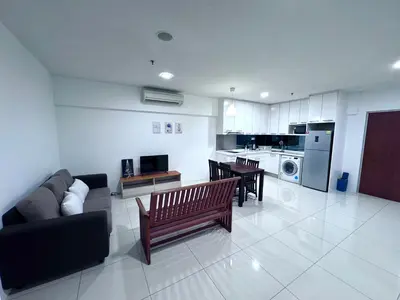 a living room with a couch and tables and a kitchen at Mercu Summer suites KLCC by JK Privy Homes - 7 Pax Family Stay in Kuala Lumpur