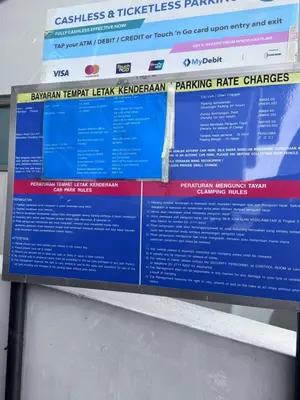 a sign for the korean korean help koreanorean parking charges at Mercu Summer suites KLCC by JK Privy Homes - 7 Pax Family Stay in Kuala Lumpur