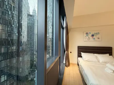 a bedroom with a bed and a large window at KL Star Residance by Nexus 52 in Kuala Lumpur
