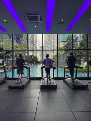 a group of people running on a treadmill in a gym at KL Star Residance by Nexus 52 in Kuala Lumpur