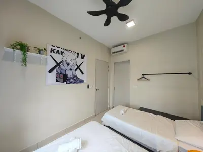 a bedroom with two beds and a ceiling fan at TRION The 107 Family Suites POOL VIEW in Kuala Lumpur