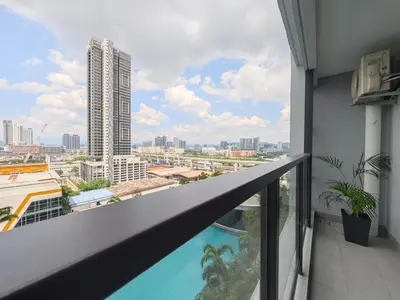 a balcony with a view of a city at TRION The 107 Family Suites POOL VIEW in Kuala Lumpur