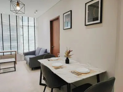 a dining room with a table and a couch at KLCC Luxe High speed wifi 2BR Residence in Kuala Lumpur