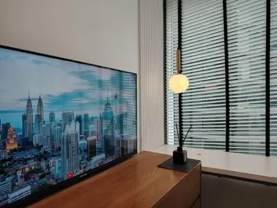 a large television in a room with a large window at KLCC Luxe High speed wifi 2BR Residence in Kuala Lumpur