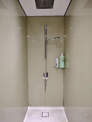 a shower in a bathroom with a glass door at KLCC Luxe High speed wifi 2BR Residence in Kuala Lumpur