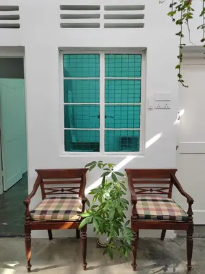 two wooden chairs sitting in front of a window at Zen Retreat KL in Kuala Lumpur
