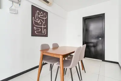a dining room with a wooden table and chairs at Blueground Kampung Baru pool nr KL Tower KUL-9 in Kuala Lumpur