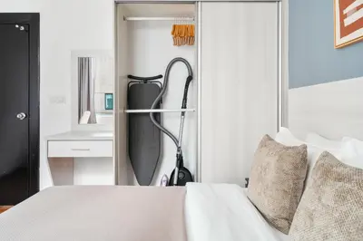 a bedroom with a white bed and a mirror at Blueground Kampung Baru pool nr KL Tower KUL-9 in Kuala Lumpur
