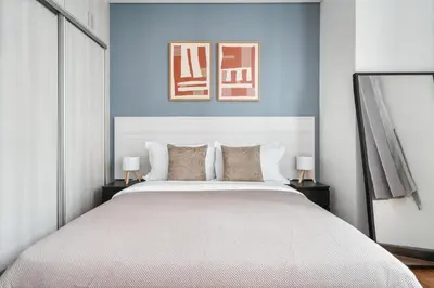 a bedroom with a large bed with blue walls at Blueground Kampung Baru pool nr KL Tower KUL-9 in Kuala Lumpur