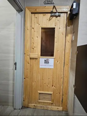 a wooden door in a room with a sign on it at Continew Residence by TM House in Kuala Lumpur