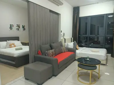 a living room with a couch and a bed at Continew Residence by TM House in Kuala Lumpur