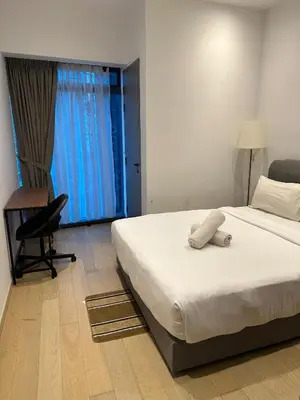 a bedroom with a bed and a chair and a desk at Eaton Residence KLCC by Majestic Hospitality in Kuala Lumpur
