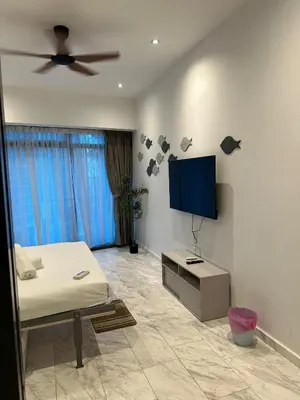 a bedroom with a bed and a flat screen tv at Eaton Residence KLCC by Majestic Hospitality in Kuala Lumpur