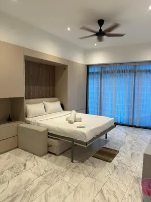 a bedroom with a bed and a ceiling fan at Eaton Residence KLCC by Majestic Hospitality in Kuala Lumpur