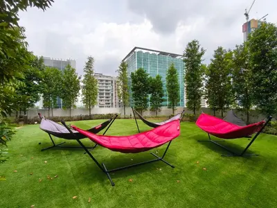 two hammocks sitting on a lawn in a park at Agile Residence Bukit Bintang Serviced Suite by LP in Kuala Lumpur