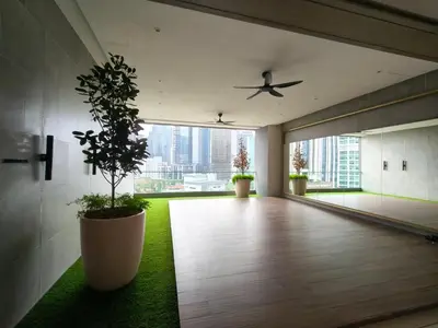 an empty room with a plant in a large pot at Agile Residence Bukit Bintang Serviced Suite by LP in Kuala Lumpur