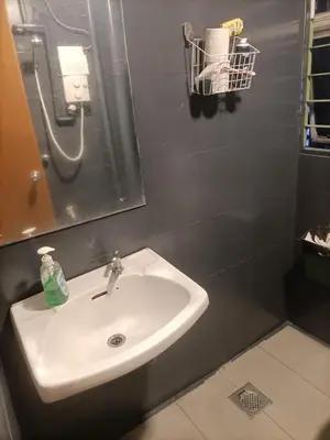 a bathroom with a sink and a mirror at Cozy Hostel City Central in Kuala Lumpur