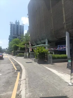 an empty street in front of a building at Cozy Hostel City Central in Kuala Lumpur