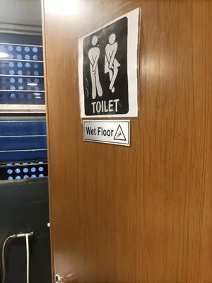 a door with a toilet sign on it at Cozy Hostel City Central in Kuala Lumpur