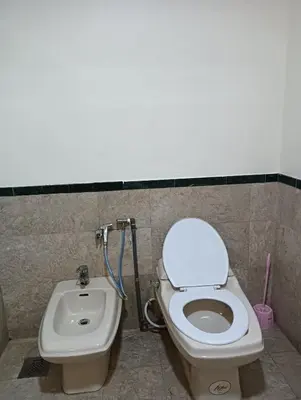 a bathroom with a toilet and a bidet at Royal Service Suite At Berjaya Times Square in Kuala Lumpur