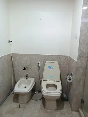 a bathroom with a toilet and a sink at Royal Service Suite At Berjaya Times Square in Kuala Lumpur