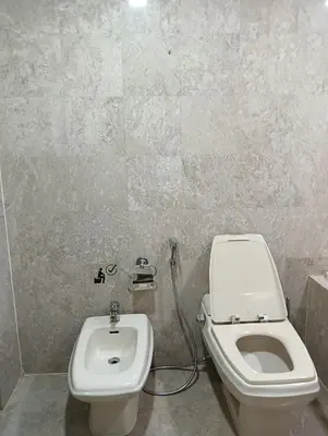 a bathroom with a toilet and a sink at Royal Service Suite At Berjaya Times Square in Kuala Lumpur