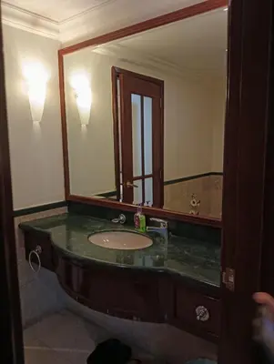 a bathroom with a sink and a large mirror at Royal Service Suite At Berjaya Times Square in Kuala Lumpur