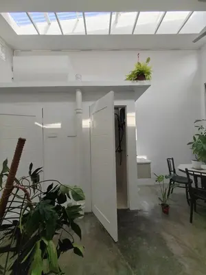 a room with a table and chairs and a ceiling at Zen 1 Room KL in Kuala Lumpur