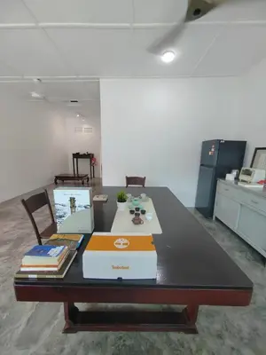 an office table with a laptop and books on it at Zen 1 Room KL in Kuala Lumpur