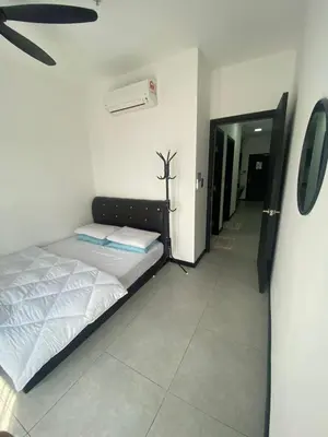 a bedroom with a bed and a air conditioner at Neu Suite by Triple A in Kuala Lumpur