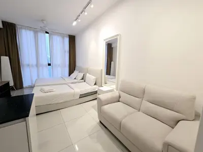 a white room with a couch and a bed and a sofa at City centre Majestice Suite KLCC in Kuala Lumpur