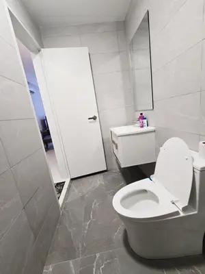 a white bathroom with a toilet and a sink at City centre Majestice Suite KLCC in Kuala Lumpur