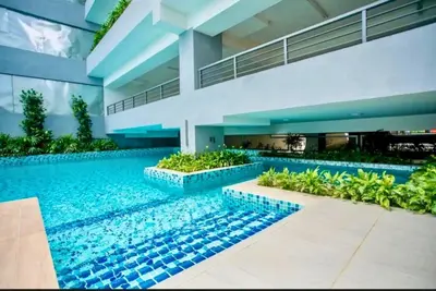 a house with a swimming pool in front of it at Cozy, Mini Studio Apartment at Neu Suites by OKBnB in Kuala Lumpur