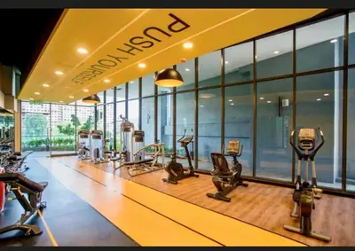 a gym with a row of treadmills and elliptical machines at Cozy, Mini Studio Apartment at Neu Suites by OKBnB in Kuala Lumpur