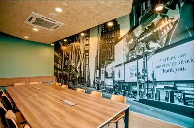 a conference room with a wooden table and chairs at Cozy, Mini Studio Apartment at Neu Suites by OKBnB in Kuala Lumpur