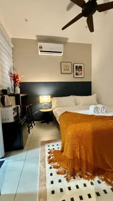 a bedroom with a bed and a ceiling fan at Cozy, Mini Studio Apartment at Neu Suites by OKBnB in Kuala Lumpur