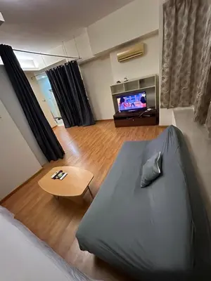 a bedroom with a bed and a flat screen tv at park view one bedroom apartment klcc in Kuala Lumpur