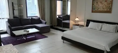 a bedroom with a bed and a couch and a living room at MY HOMEs TIMES SQUARE in Kuala Lumpur