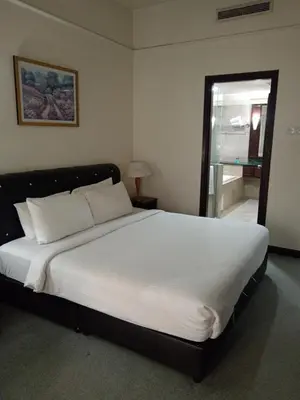 a bedroom with a large white bed with a window at MY HOMEs TIMES SQUARE in Kuala Lumpur