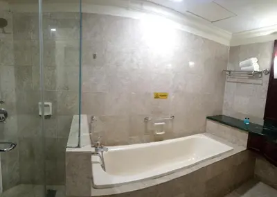 a bathroom with a tub and a glass shower at MY HOMEs TIMES SQUARE in Kuala Lumpur