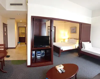 a hotel room with a bed and a television at MY HOMEs TIMES SQUARE in Kuala Lumpur