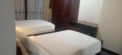 a small room with two beds and a mirror at MY HOMEs TIMES SQUARE in Kuala Lumpur