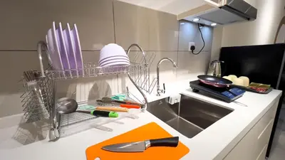 a kitchen with a sink and utensils on a counter at Majestic Residence sky pool 10mins to KLCC By Light House in Kuala Lumpur