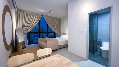 a hotel room with a bed and a bathroom at Majestic Residence sky pool 10mins to KLCC By Light House in Kuala Lumpur