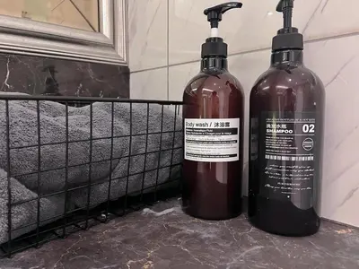 two bottles of wine sitting on a shelf in a bathroom at Dorsett Hartamas Mont Kiara Kuala Lumpur Mitec by innfinitystay in Kuala Lumpur