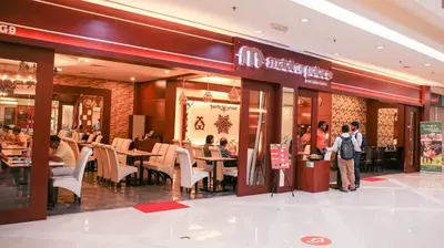 a restaurant with people sitting at tables in a mall at Dorsett Hartamas Mont Kiara Kuala Lumpur Mitec by innfinitystay in Kuala Lumpur