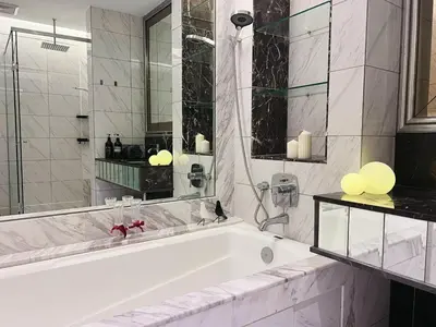 a white bathroom with a tub and a mirror at Dorsett Hartamas Mont Kiara Kuala Lumpur Mitec by innfinitystay in Kuala Lumpur